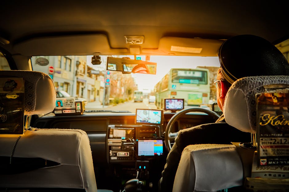 Experience a scenic ride through Kyoto in a traditional taxi, capturing urban life during sunset.